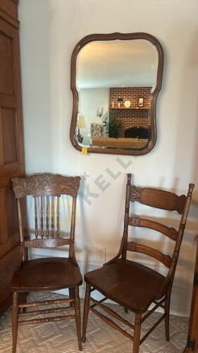 Two Wooden Chairs and a Wall Mirror