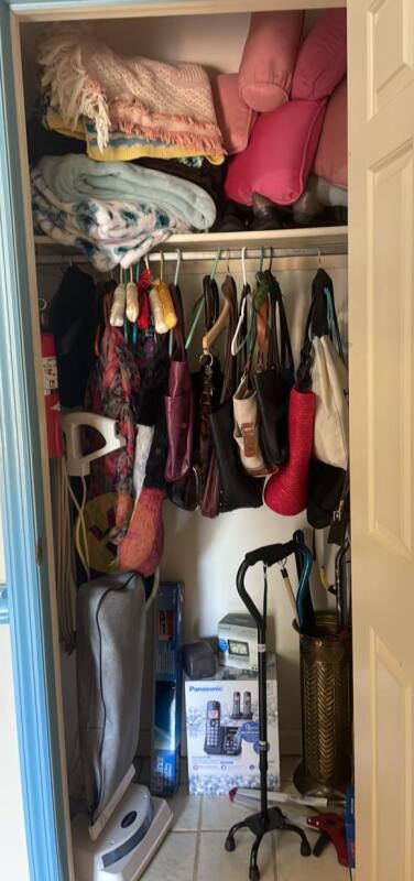 Contents of Closet with Vacuum, Phone, and More