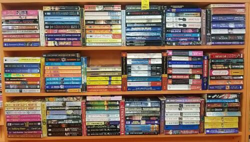 Variety of Paperback Mystery Novels On 3 Shelves