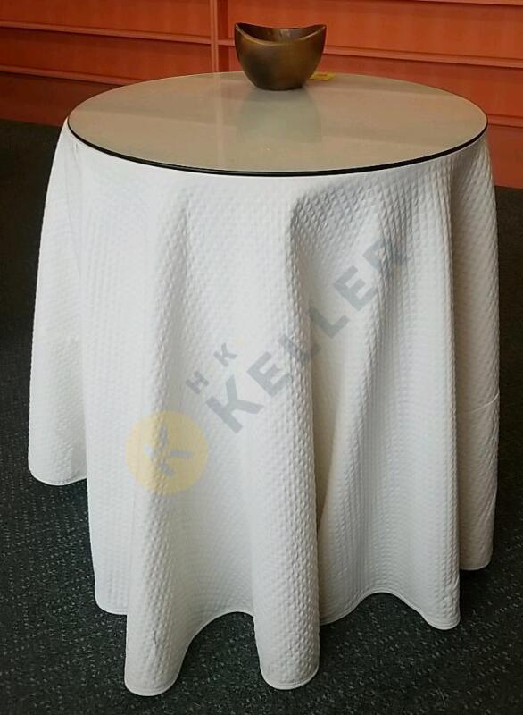 Table with Tablecloth, Glass Top, and Wooden Bowl