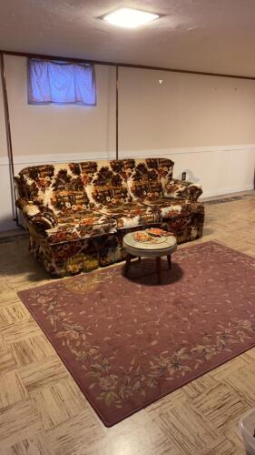 Sofa, Rug, Footstool, and Wall Decor