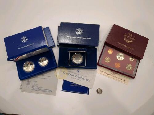 1986 Liberty Silver Dollar and Half Dollar Proof Set, 1987 Silver Dollar Proof, 1992 Uncirculated Coin Set, and a 1981 Nickel